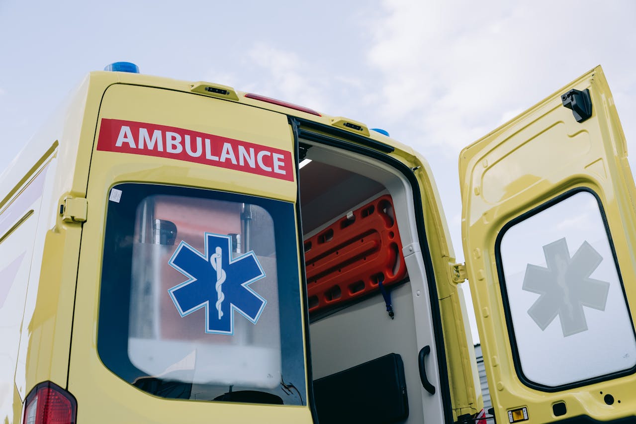 a-yellow-colored-ambulance-with-one-of-its-rear-doors-open
